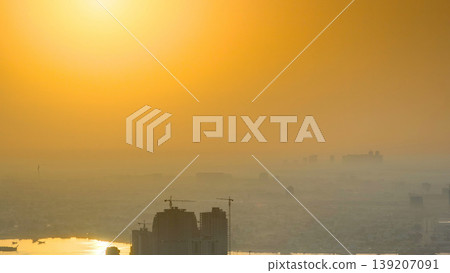 Sunrise with cityscape of Ajman from rooftop aerial timelapse. 139207091
