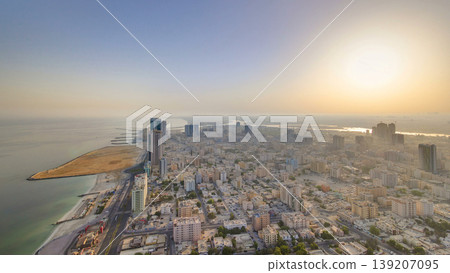Sunrise with cityscape of Ajman from rooftop aerial timelapse. Sunrise with cityscape of Ajman from rooftop aerial timelapse. 139207095