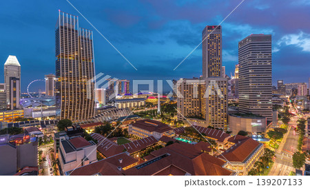 Evening panorama with Marina Bay area and skyscrapers city skyline aerial day to night timelapse. Evening panorama with Marina Bay area and skyscrapers city skyline aerial day to night timelapse. 139207133