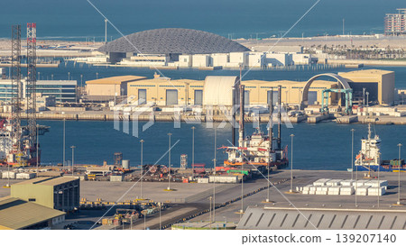 Big cargo ship at industrial port timelapse aerial fiew from above at evening in Abu Dhabi Big cargo ship at industrial port timelapse aerial fiew from above at evening in Abu Dhabi 139207140