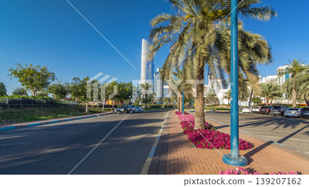 Corniche boulevard beach park along the coastline in Abu Dhabi timelapse hyperlapse with skyscrapers on background. 139207162