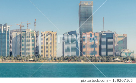 View of high skyscrapers on a corniche in Abu Dhabi stretching alongside the business center timelapse. View of high skyscrapers on a corniche in Abu Dhabi stretching alongside the business center timelapse. 139207165