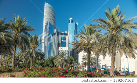Corniche boulevard beach park along the coastline in Abu Dhabi timelapse with skyscrapers on background. 139207168