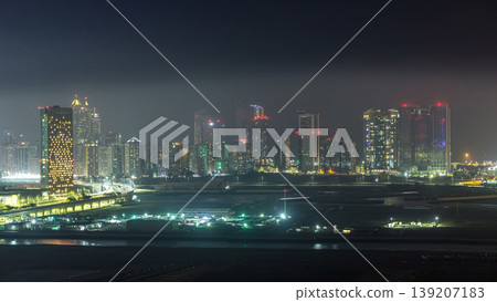 Buildings on Al Reem island in Abu Dhabi night timelapse from above. Buildings on Al Reem island in Abu Dhabi night timelapse from above. 139207183