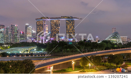 Aerial view after sunset with Singapore city skyline view from Marina barrage garden day to night timelapse. 139207241