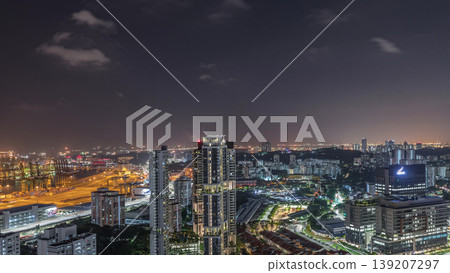 City skyline with commercial port of Singapore aerial night timelapse. City skyline with commercial port of Singapore aerial night timelapse. 139207297