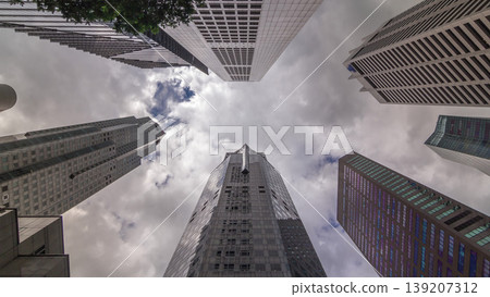 Looking up perspective of modern business skyscrapers glass and sky view landscape of commercial building in central city timelapse Looking up perspective of modern business skyscrapers glass and sky view landscape of commercial building in central city timelapse 139207312