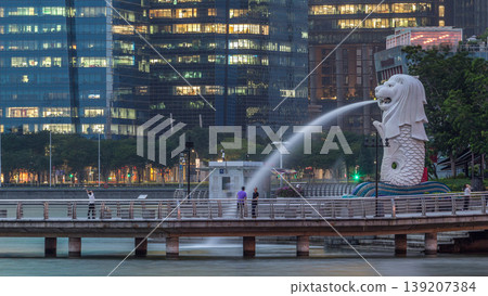 The Merlion fountain and Singapore skyline night to day timelapse. 139207384