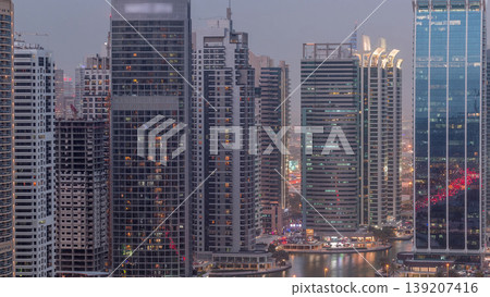 Residential and office buildings in Jumeirah lake towers district day to night timelapse in Dubai Residential and office buildings in Jumeirah lake towers district day to night timelapse in Dubai 139207416