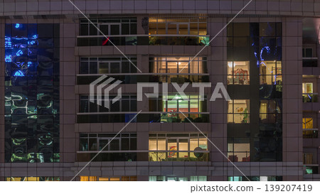 Night view of exterior apartment building timelapse. High rise skyscraper with blinking lights in windows Night view of exterior apartment building timelapse. High rise skyscraper with blinking lights in windows 139207419