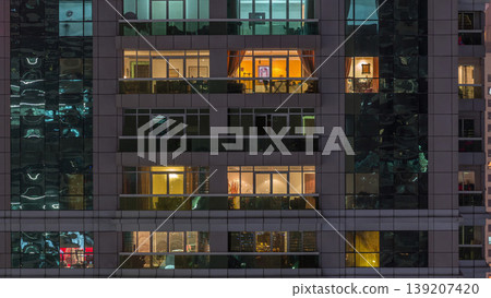 Night view of exterior apartment building timelapse. High rise skyscraper with blinking lights in windows Night view of exterior apartment building timelapse. High rise skyscraper with blinking lights in windows 139207420