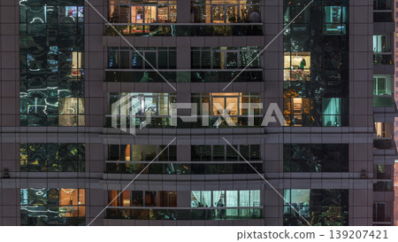 Night view of exterior apartment building timelapse. High rise skyscraper with blinking lights in windows Night view of exterior apartment building timelapse. High rise skyscraper with blinking lights in windows 139207421