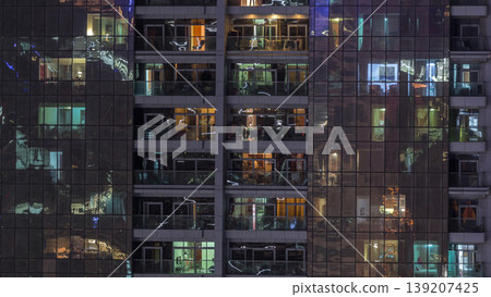 Night view of exterior apartment building timelapse. High rise skyscraper with blinking lights in windows Night view of exterior apartment building timelapse. High rise skyscraper with blinking lights in windows 139207425