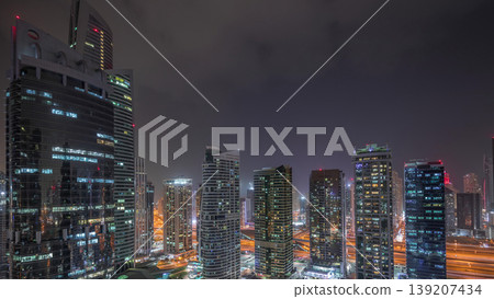 Residential and office buildings in Jumeirah lake towers district night timelapse in Dubai 139207434