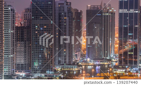 Residential and office buildings in Jumeirah lake towers district night to day timelapse in Dubai 139207440