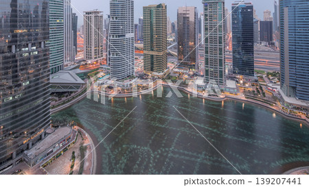 Residential and office buildings in Jumeirah lake towers district night to day timelapse in Dubai Residential and office buildings in Jumeirah lake towers district night to day timelapse in Dubai 139207441
