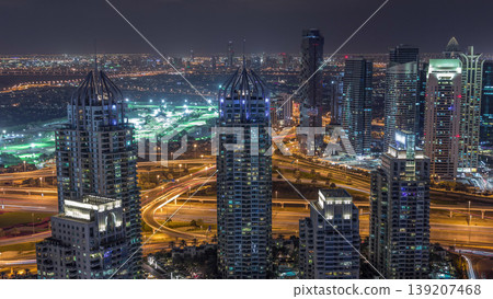 Dubai Marina skyscrapers and jumeirah lake towers view from the top aerial night timelapse in the United Arab Emirates. Dubai Marina skyscrapers and jumeirah lake towers view from the top aerial night timelapse in the United Arab Emirates. 139207468