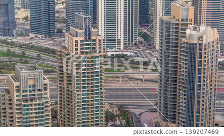 Dubai Marina skyscrapers and jumeirah lake towers view from the top aerial timelapse in the United Arab Emirates. Dubai Marina skyscrapers and jumeirah lake towers view from the top aerial timelapse in the United Arab Emirates. 139207469