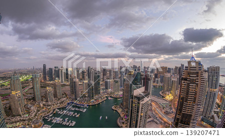 Dubai Marina skyscrapers and jumeirah lake towers view from the top aerial day to night timelapse in the United Arab Emirates. 139207471