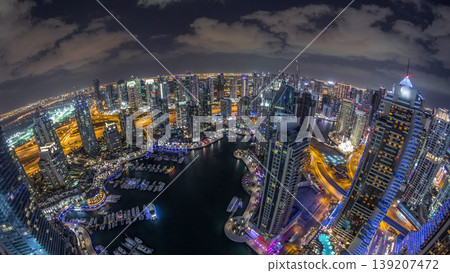 Dubai Marina skyscrapers and jumeirah lake towers view from the top aerial night timelapse in the United Arab Emirates. Dubai Marina skyscrapers and jumeirah lake towers view from the top aerial night timelapse in the United Arab Emirates. 139207472