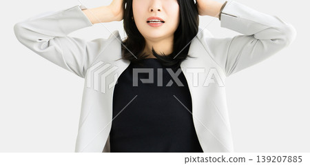 A woman/businesswoman holding her head in trouble 139207885