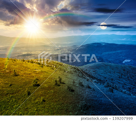 day meet night. mountain landscape with alpine meadow. sun and moon over carpathian mountain scenery on summer solstice. view in to the distant valley landscape. rolling hills and grassy meadow day meet night. mountain landscape with alpine meadow. sun and moon over carpathian mountain scenery on summer solstice. view in to the distant valley landscape. rolling hills and grassy meadow 139207999