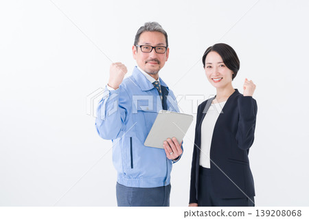 Business (a man in work clothes making a victory pose and a woman in a suit) Business (a man in work clothes making a victory pose and a woman in a suit) 139208068