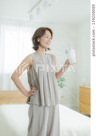  Woman drinking protein 139208089