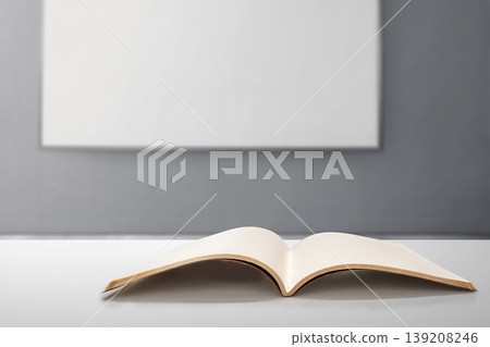 Minimalist open blank book mockup on a white desk with a blurred whiteboard background. Ideal for publishing, education, business presentations, and creative journal design 139208246