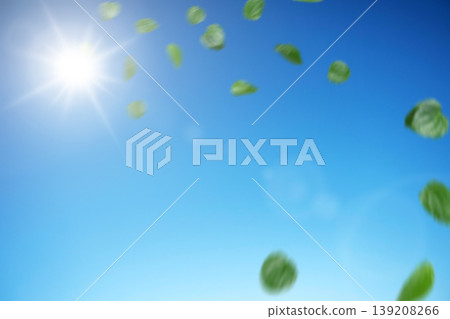 Beautiful spring or summer day with green leaves dancing in the breeze against a bright blue sky and shining sun. Perfect for eco-friendly and nature themes 139208266