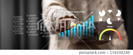 A person interacts with a futuristic digital dashboard showing growth charts, pie graphs, and a risk assessment meter for business performance tracking and strategic planning A person interacts with a futuristic digital dashboard showing growth charts, pie graphs, and a risk assessment meter for business performance tracking and strategic planning 139208280