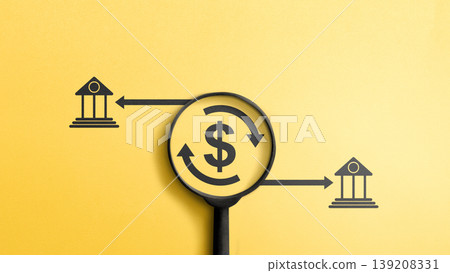 Conceptual image showing money flow between banks under scrutiny. A magnifying glass focuses on a dollar sign, representing financial transparency and international transfers on a yellow background Conceptual image showing money flow between banks under scrutiny. A magnifying glass focuses on a dollar sign, representing financial transparency and international transfers on a yellow background 139208331