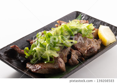 Bite-sized grilled beef tongue with green onions and salt. Bite-sized grilled beef tongue with green onions and salt. 139208583