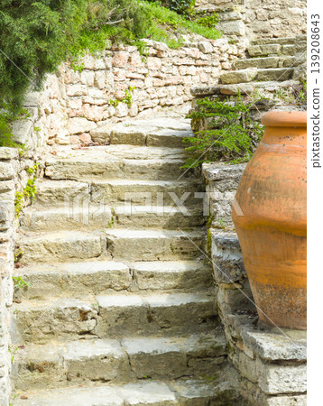 stone staircase with an antique amphora in the sun. 139208643