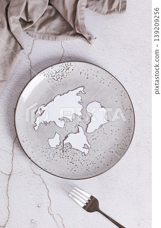 Concept of world hunger, empty plate and fork on the table top and vertical view Concept of world hunger, empty plate and fork on the table top and vertical view 139209256