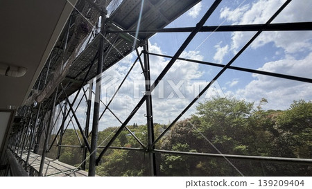 Scaffolding and protective netting for apartment building repairs and inspections. 139209404