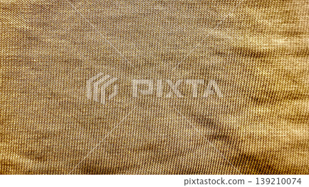 rich caramel corduroy ridges flowing in soft warm glow abstract textile closeup for seamless wallpaper or editorial background 139210074
