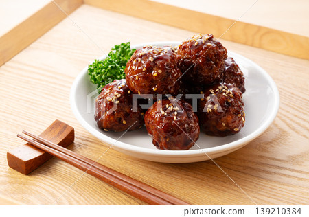 Delicious-looking meatballs in sweet and sour sauce served on a wooden tray (Japanese food, side dish) Delicious-looking meatballs in sweet and sour sauce served on a wooden tray (Japanese food, side dish) 139210384