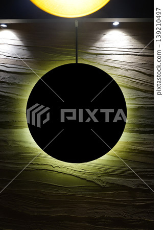 Modern minimalist wall art with black circular object and backlight, abstract rough texture background for contemporary interior design. 139210497