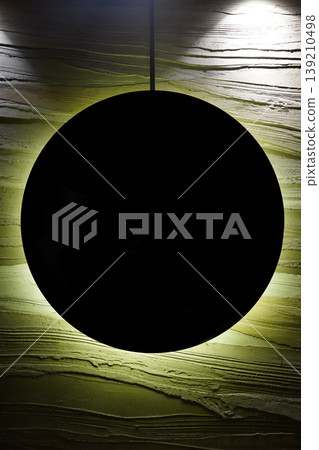 Modern minimalist wall art with black circular object and backlight, abstract rough texture background for contemporary interior design. Modern minimalist wall art with black circular object and backlight, abstract rough texture background for contemporary interior design. 139210498