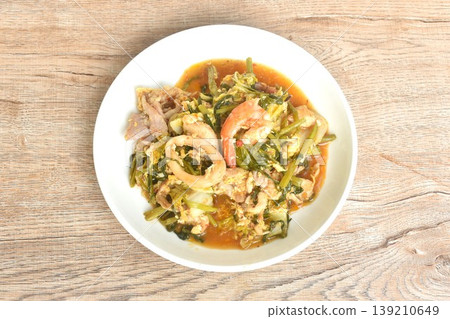 fried seafood with chicken and pork meat couple vegetable topping egg yolk in sukiyaki sauce on plate fried seafood with chicken and pork meat couple vegetable topping egg yolk in sukiyaki sauce on plate 139210649