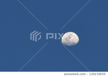 half moon floating on twilight blue sky in evening half moon floating on twilight blue sky in evening 139210650