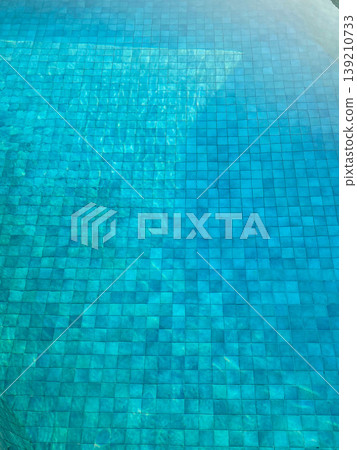 Swimming pool background. Swimming pool with clear water, with the bottom of the pool using blue and green mosaic tiles. Adds freshness to pool water. Swimming pool background. Swimming pool with clear water, with the bottom of the pool using blue and green mosaic tiles. Adds freshness to pool water. 139210733