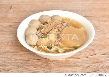 boiled meatball and braised beef meat tendon with bean sprout in clear soup on bowl 139210867