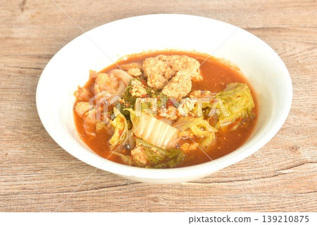boiled mixed vegetable and fish egg in Thai spicy curry soup on bowl 139210875