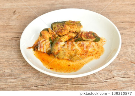 spicy fried Maekong giant catfish with herb and chili curry on plate spicy fried Maekong giant catfish with herb and chili curry on plate 139210877