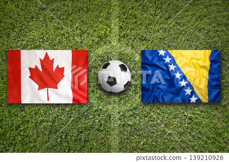 Canada vs. Bosnia Herzegovina flags on a soccer field Canada vs. Bosnia Herzegovina flags on a soccer field 139210926
