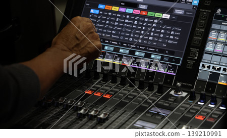 Mixing operation. Professional audio or sound engineers operating digital mixing consoles in studio or live mix perform. Sound control music production broadcasting mix and live event audio technology 139210991