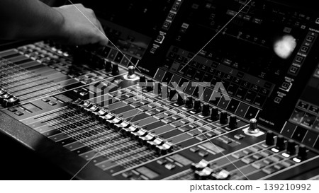 Mixing operation. Professional audio or sound engineers operating digital mixing consoles in studio or live mix perform. Sound control music production broadcasting mix and live event audio technology 139210992