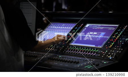 Mixing operation. Professional audio or sound engineers operating digital mixing consoles in studio or live mix perform. Sound control music production broadcasting mix and live event audio technology 139210998